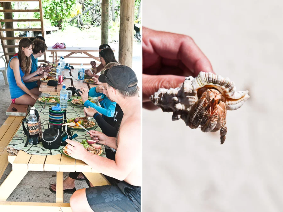 Tourists eating a traditionally cooked lunch during a day trip island hopping and snorkelling, Aitutaki Island, Cook Islands.