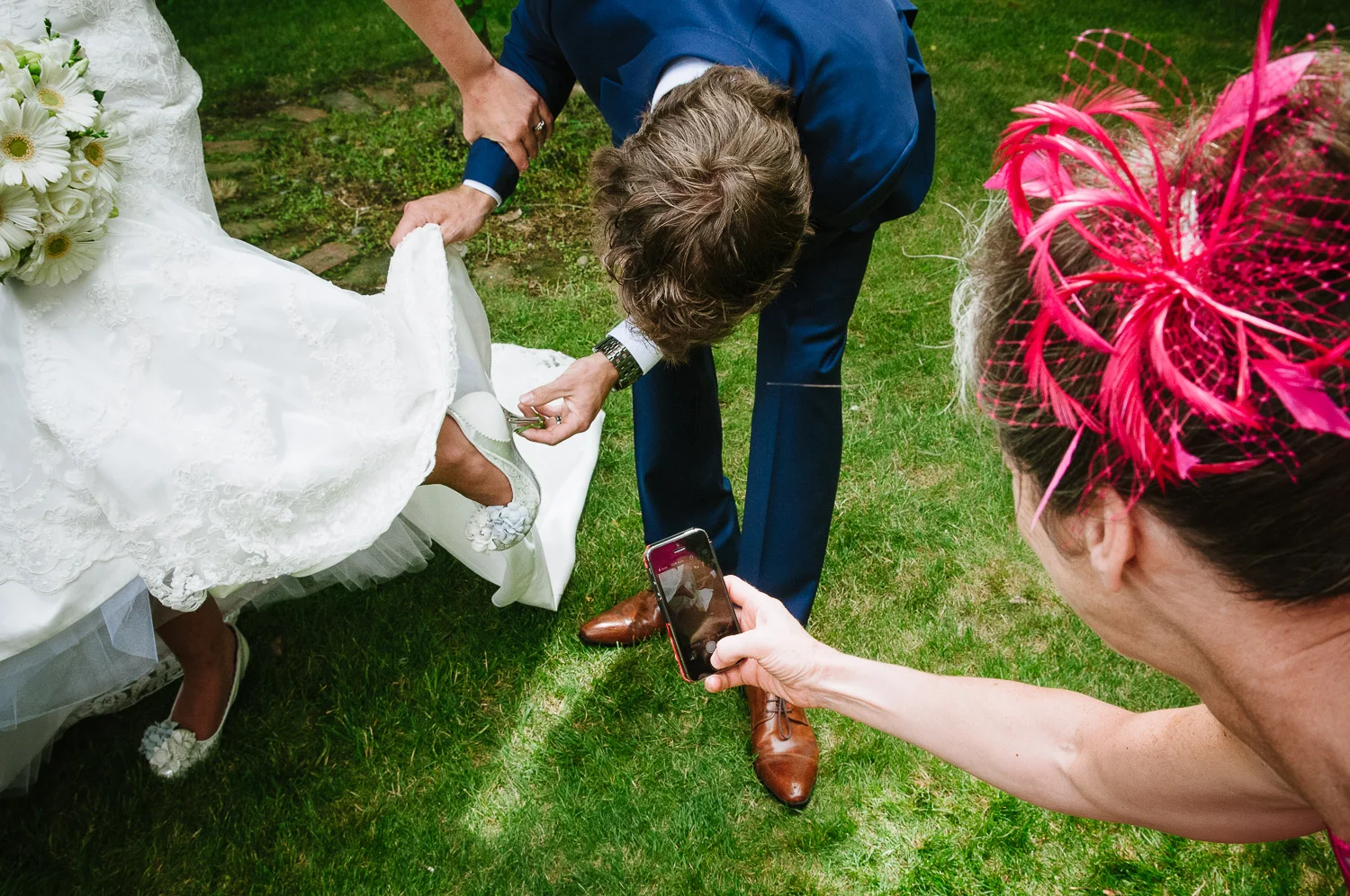 Langdale Vineyard Wedding, Jacob looks at Jodie's shoes