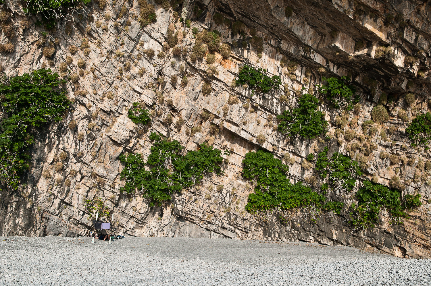 Woman lying under a tarp, during a sea kayaking trip along the Turquoise Coast Turkey.