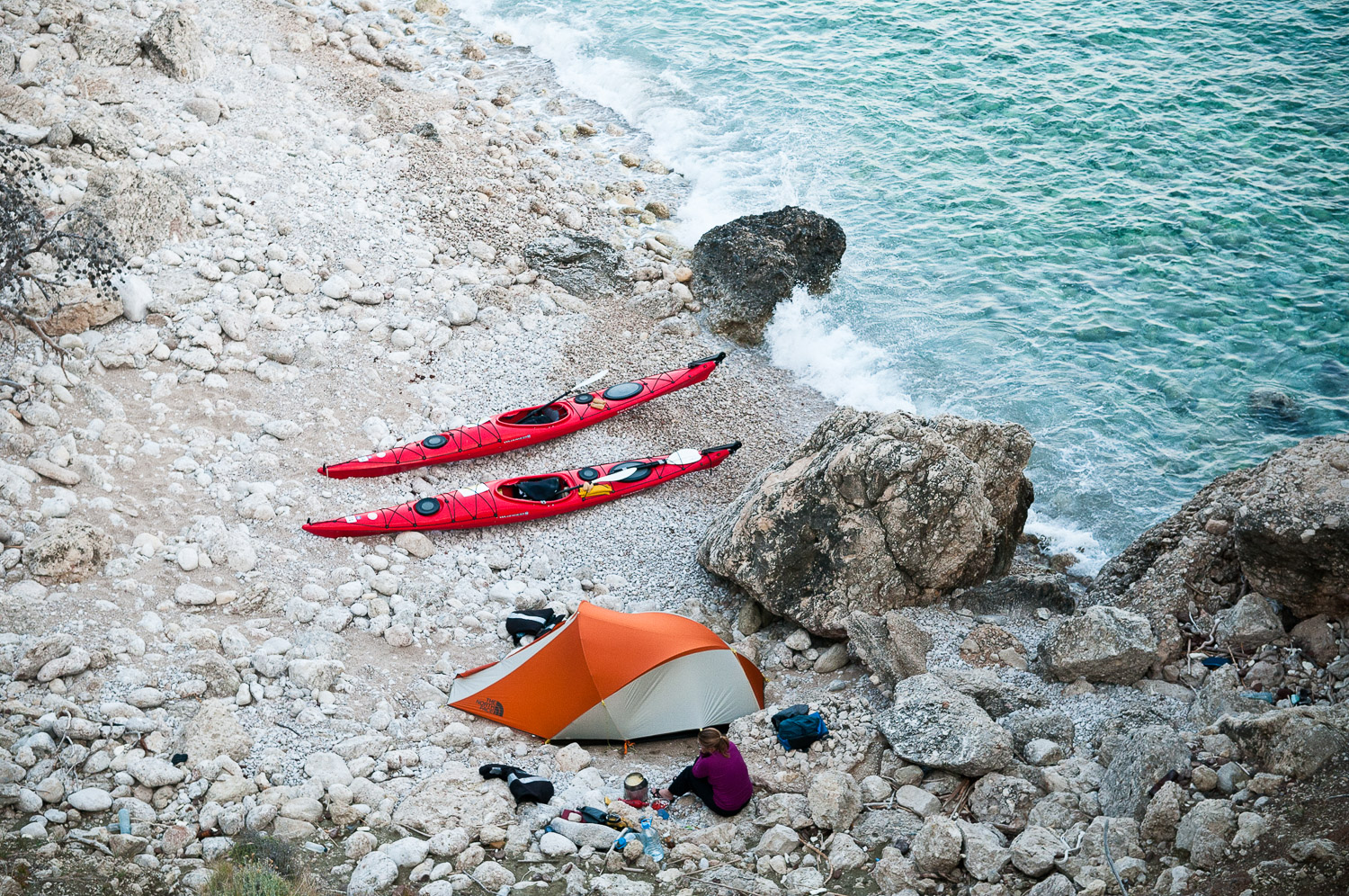 Woman sea kayaker camping, while paddling the Turquoise Coast, Turkey.
