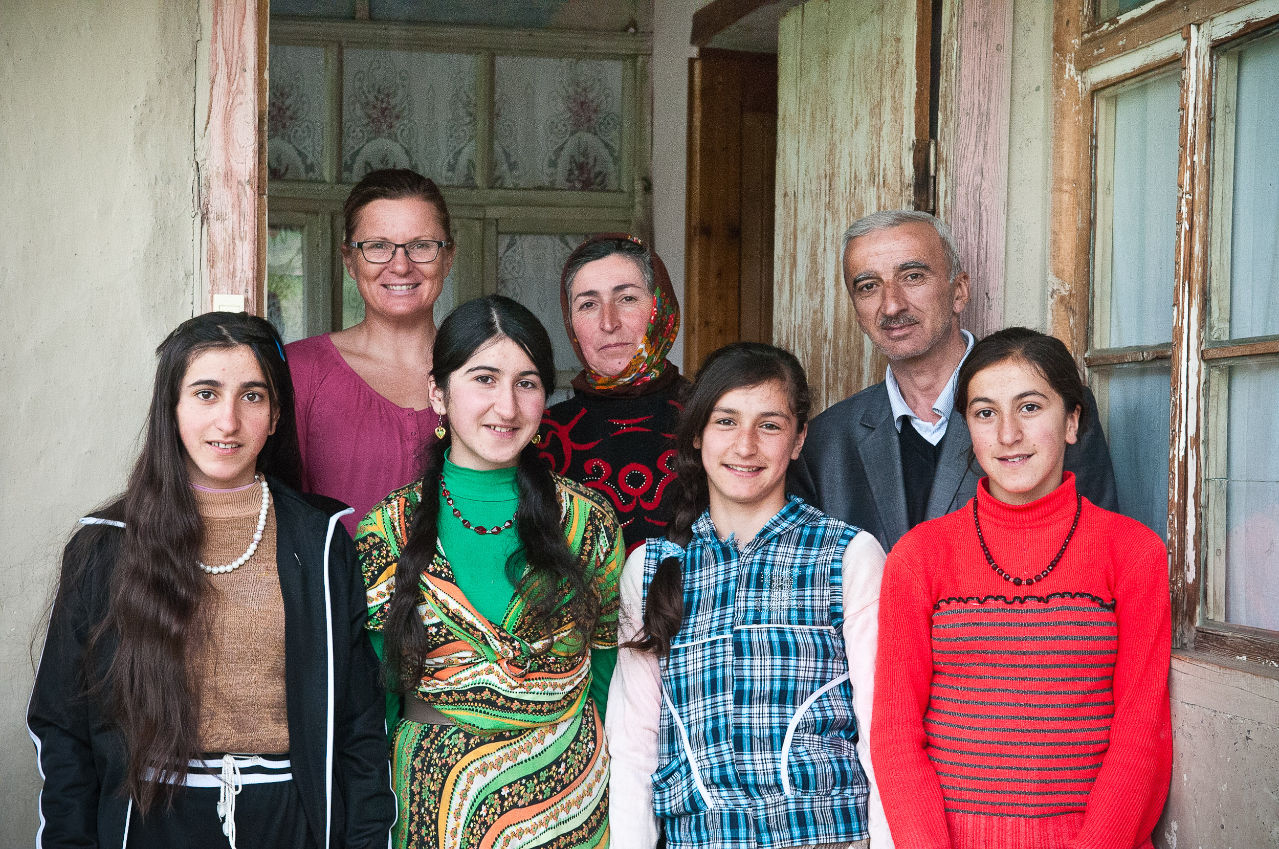 Woman traveller and homestay family, Xinaliq village, Azerbaijan.