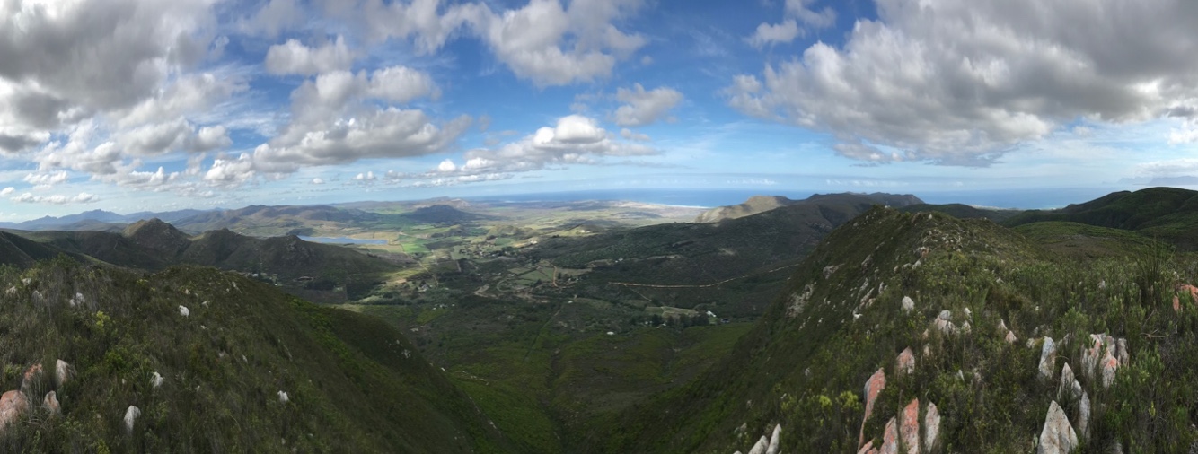 Atop the Apu (Witkrans Mountain) with Walker Bay on the horizon and the land of Bodhi Khaya down below in the center of the image