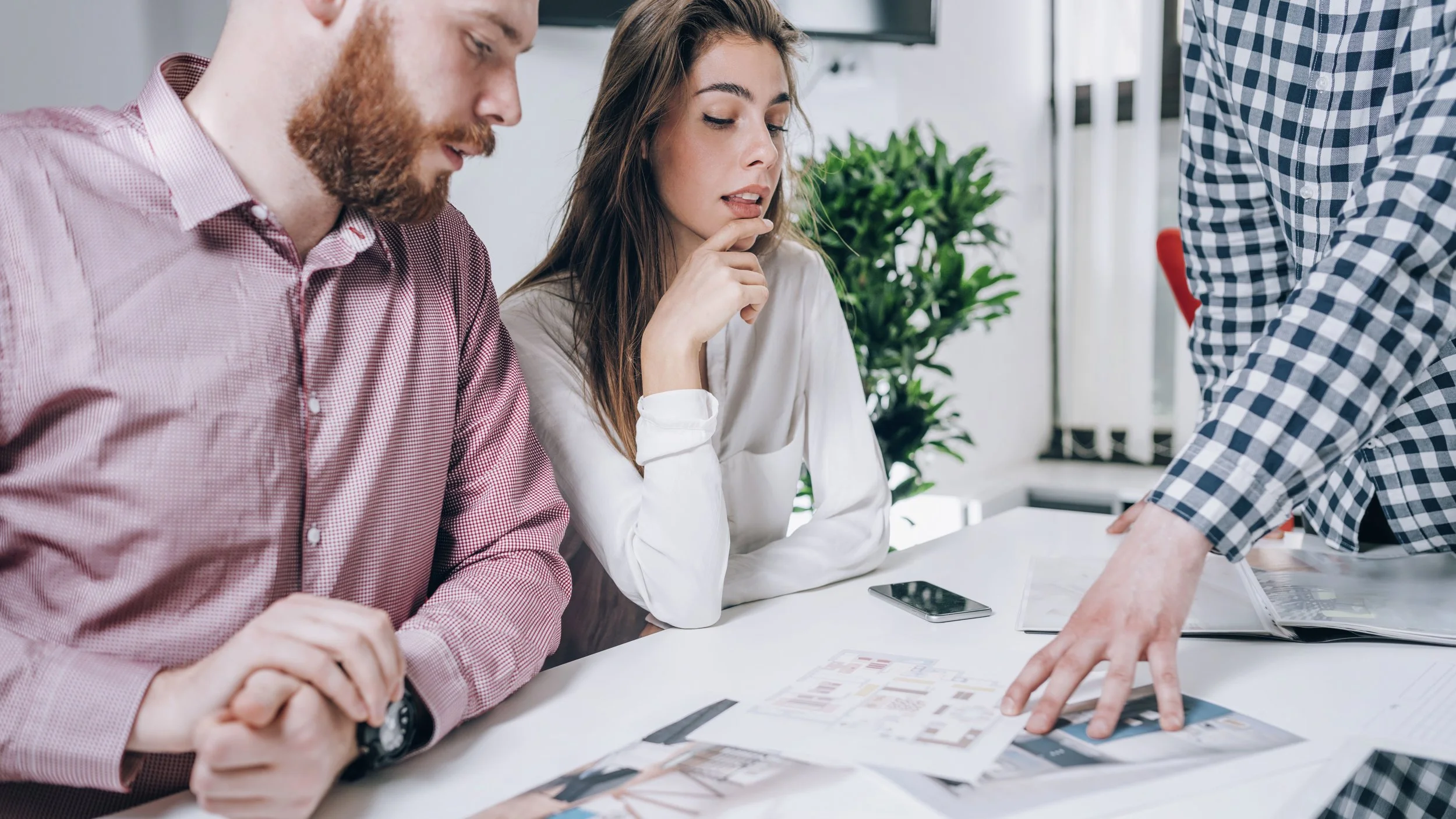 couple-in-real-estate-agency-talking-to-real-K5HXEL6-squashed.jpg
