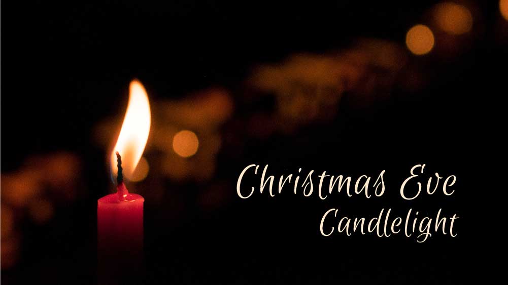 A single candle is lit in a dark environment. 'Christmas Eve Candlelight' is written at the bottom.