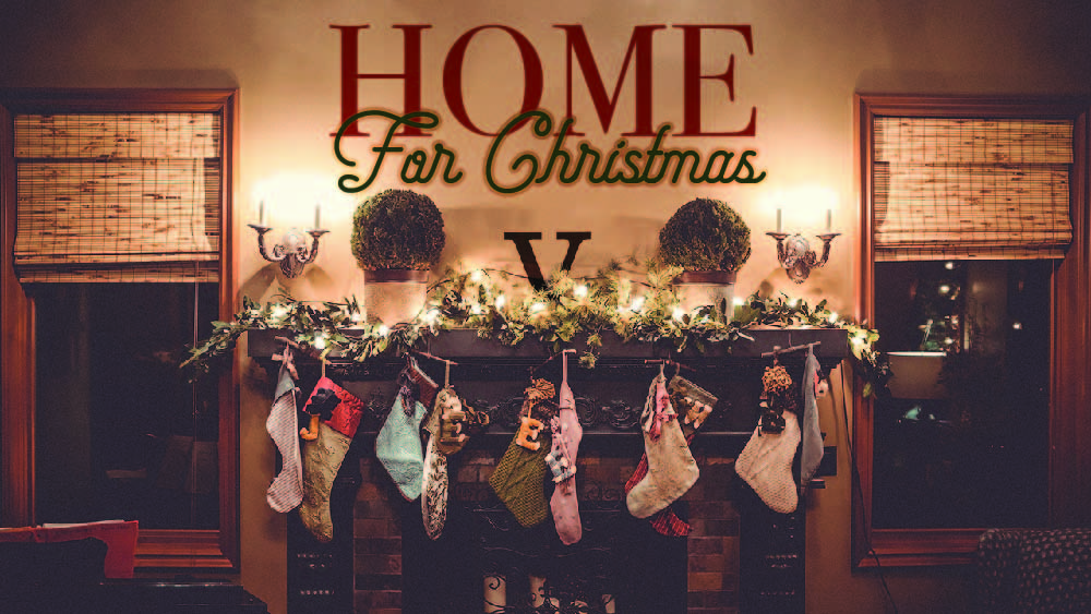 Fireplace decorated with Christmas stockings. 'Home for Christmas' is written on the mantle.