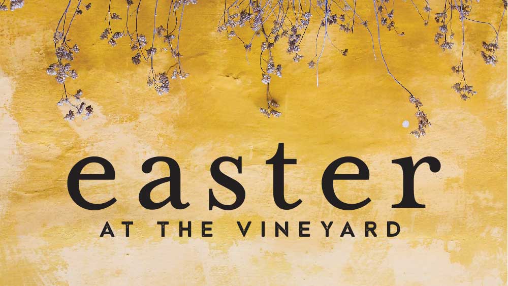 Flowers growing on a yellow wall. 'Easter at the Vineyard ' is written below them.