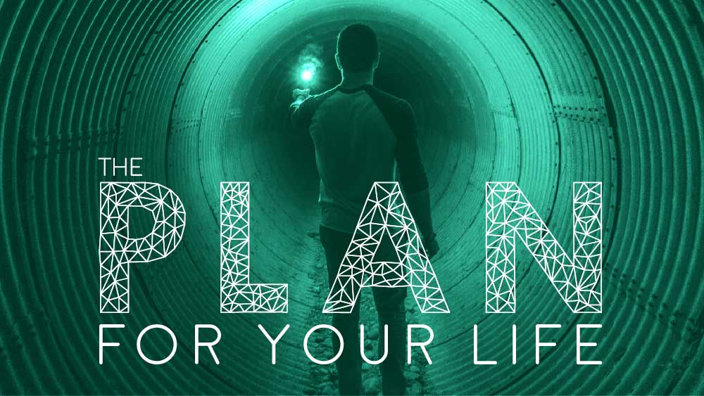 Man wanders down a large tunnel, illuminated by a single road flare. 'The Plan for Your Life' is written below him.