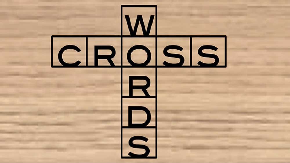 The words 'Cross Words' are burned into a plank of wood in the style of a crossword puzzle.