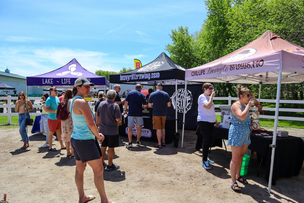  Festival goers enjoying samples at the Minnesota Craft Lager Fest. Breweries visible are Boathouse Brothers Brewing Co., Heavy Riff Brewing, and Civil Life. 