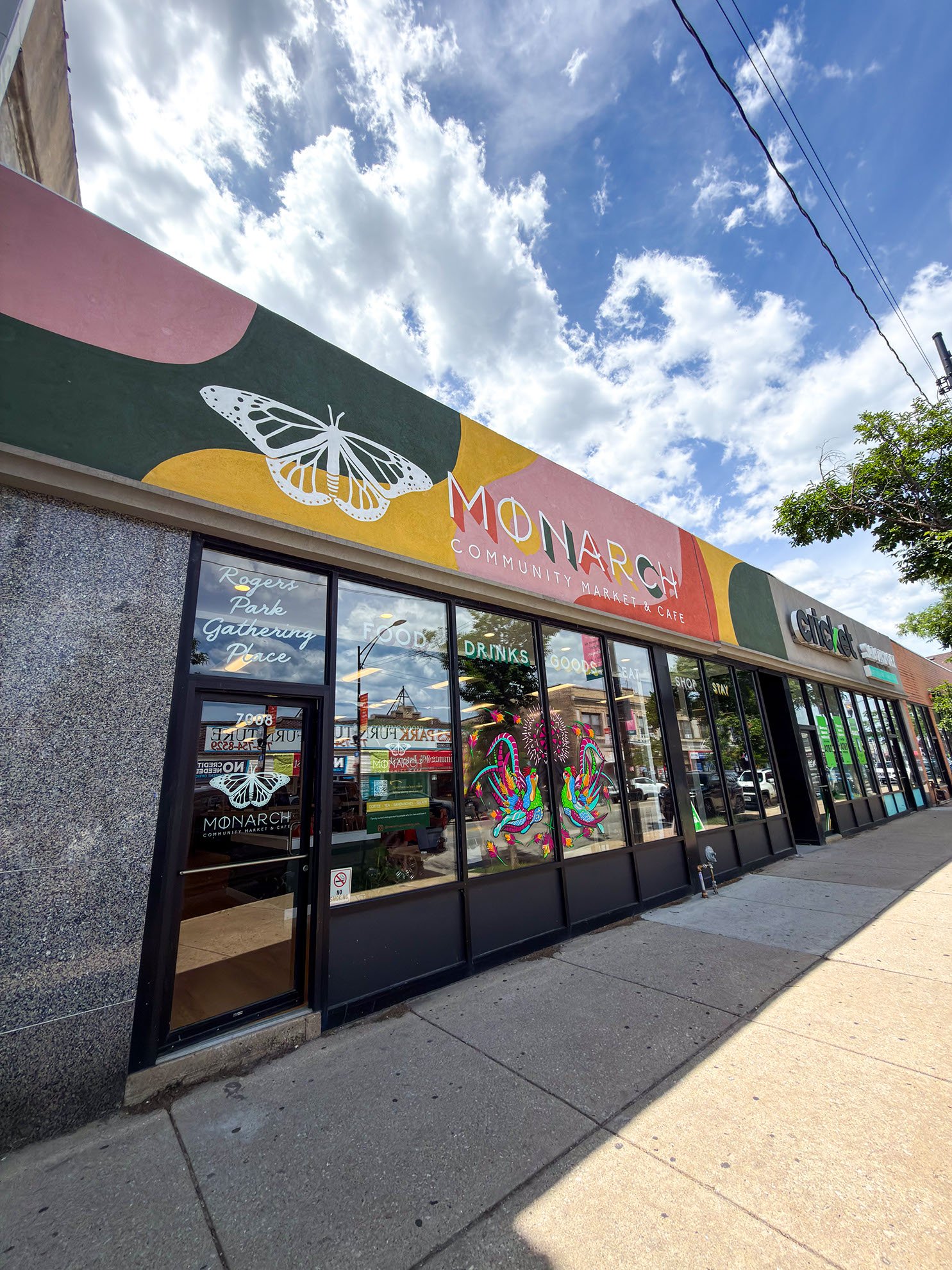 Exterior storefront signage on stucco