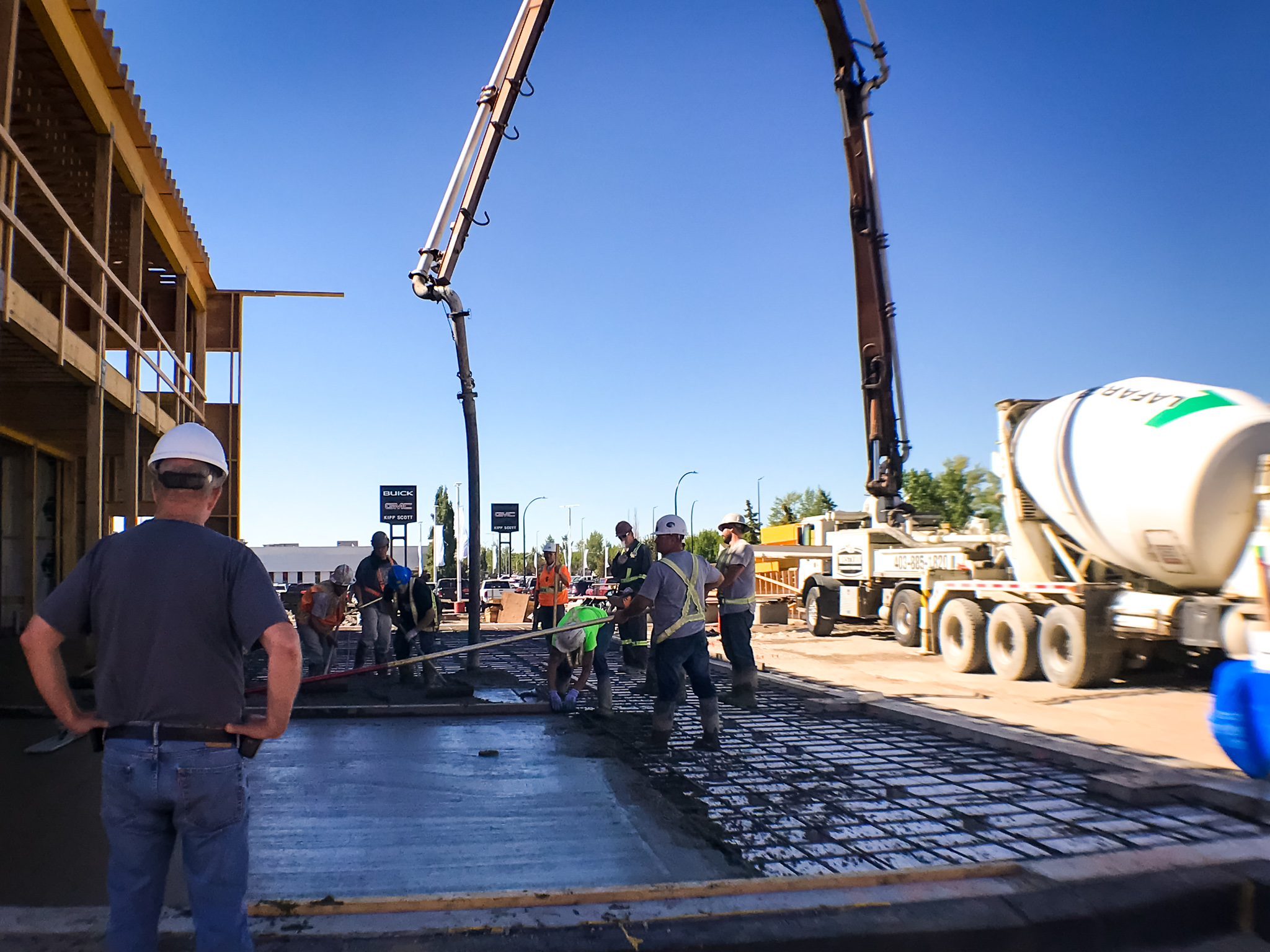 The concrete slab being poured is a major milestone, covering the heavy duty insulation beneath.