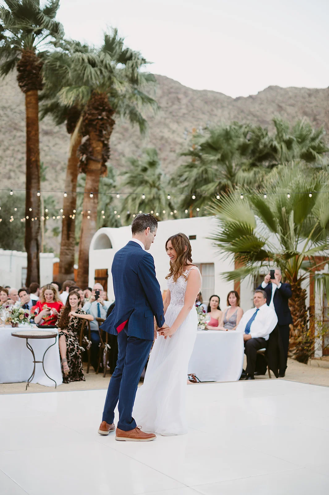Palm Springs wedding, outdoor wedding reception, first dance, bride and groom dance, lace wedding dress, dessert wedding decor, outdoor wedding || Orange Blossom Special Events