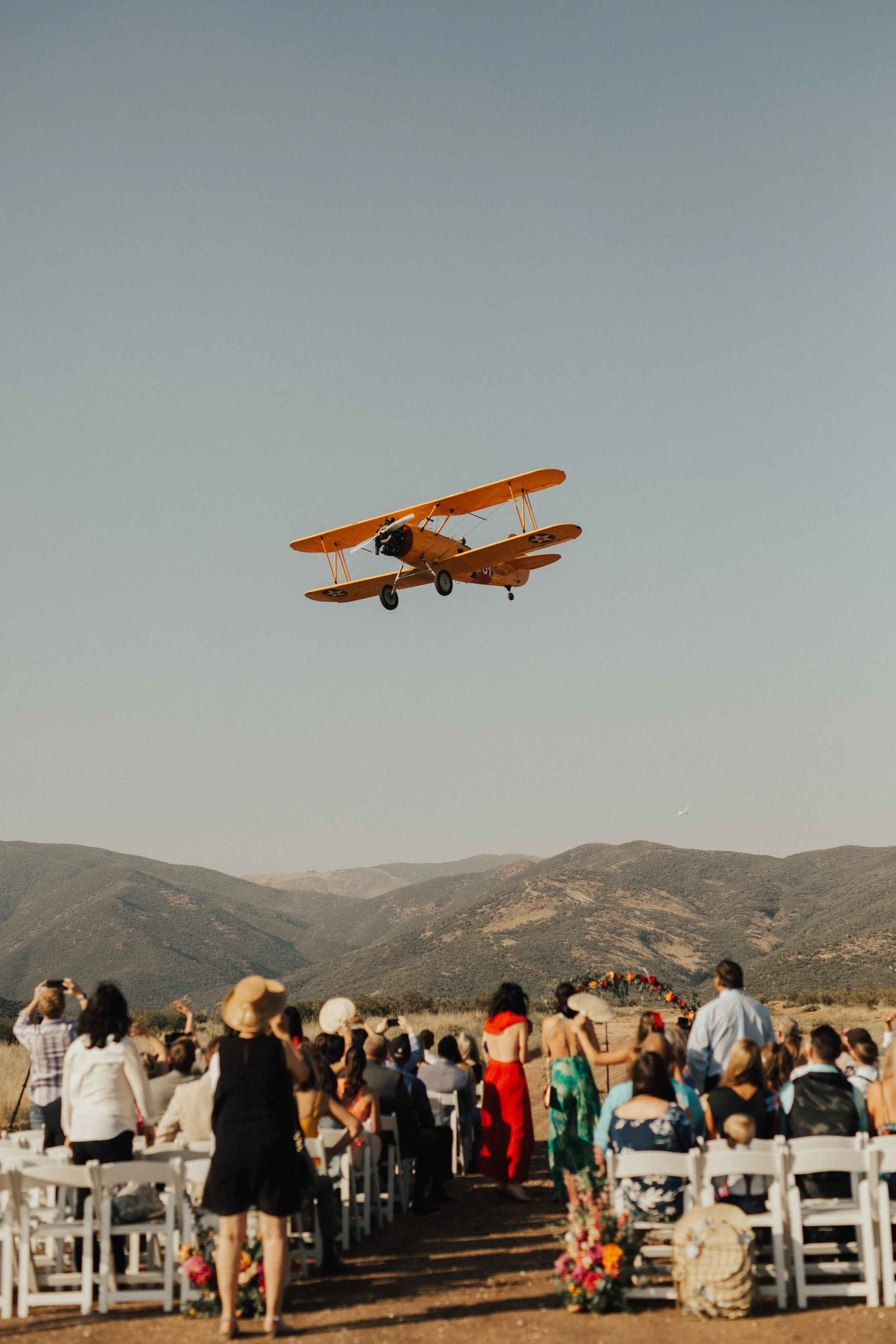 outdoor wedding ceremony, vintage airplane, mountain setting || Orange Blossom Special Events
