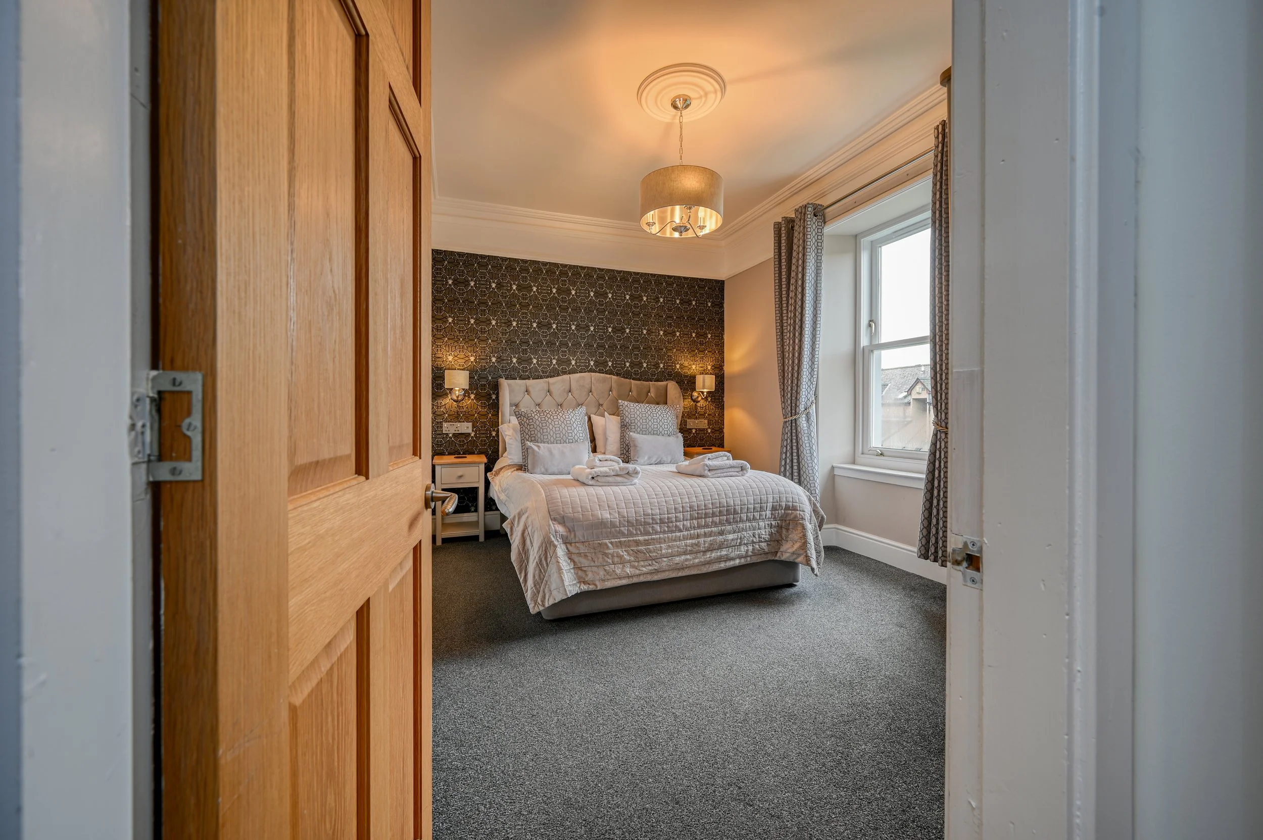 Photograph of a luxurious bedroom in a comfortable Highland home advertising Wayward Spirit Photography's standard photography package and pricing details