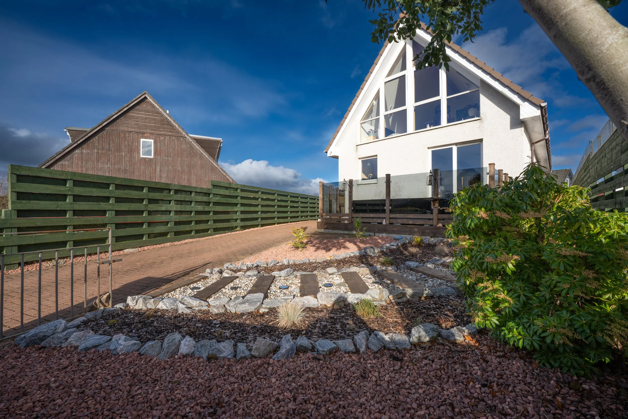 Exterior photograph of a modern white house in Inverness