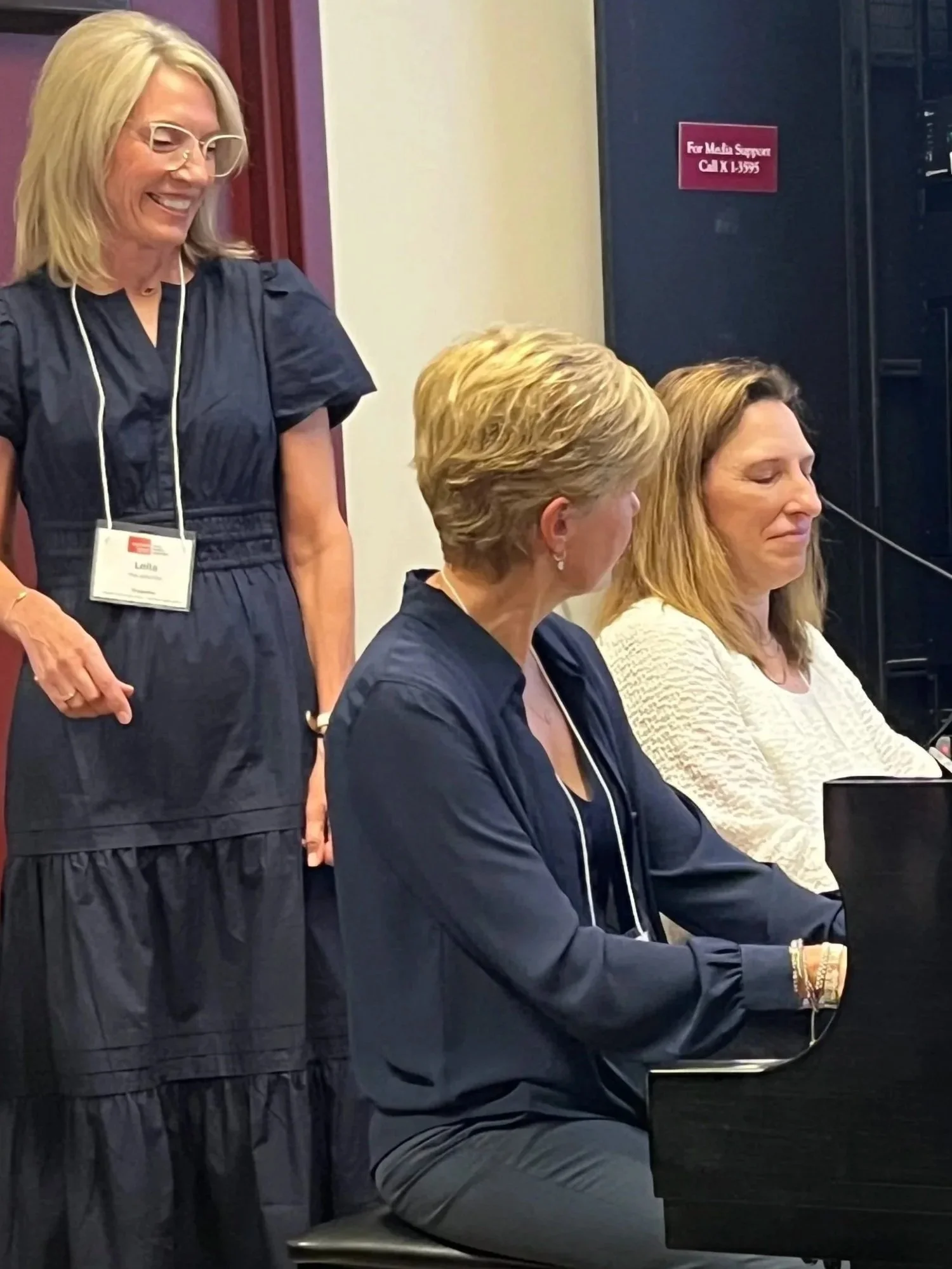 Leila coaching two pianists at the piano