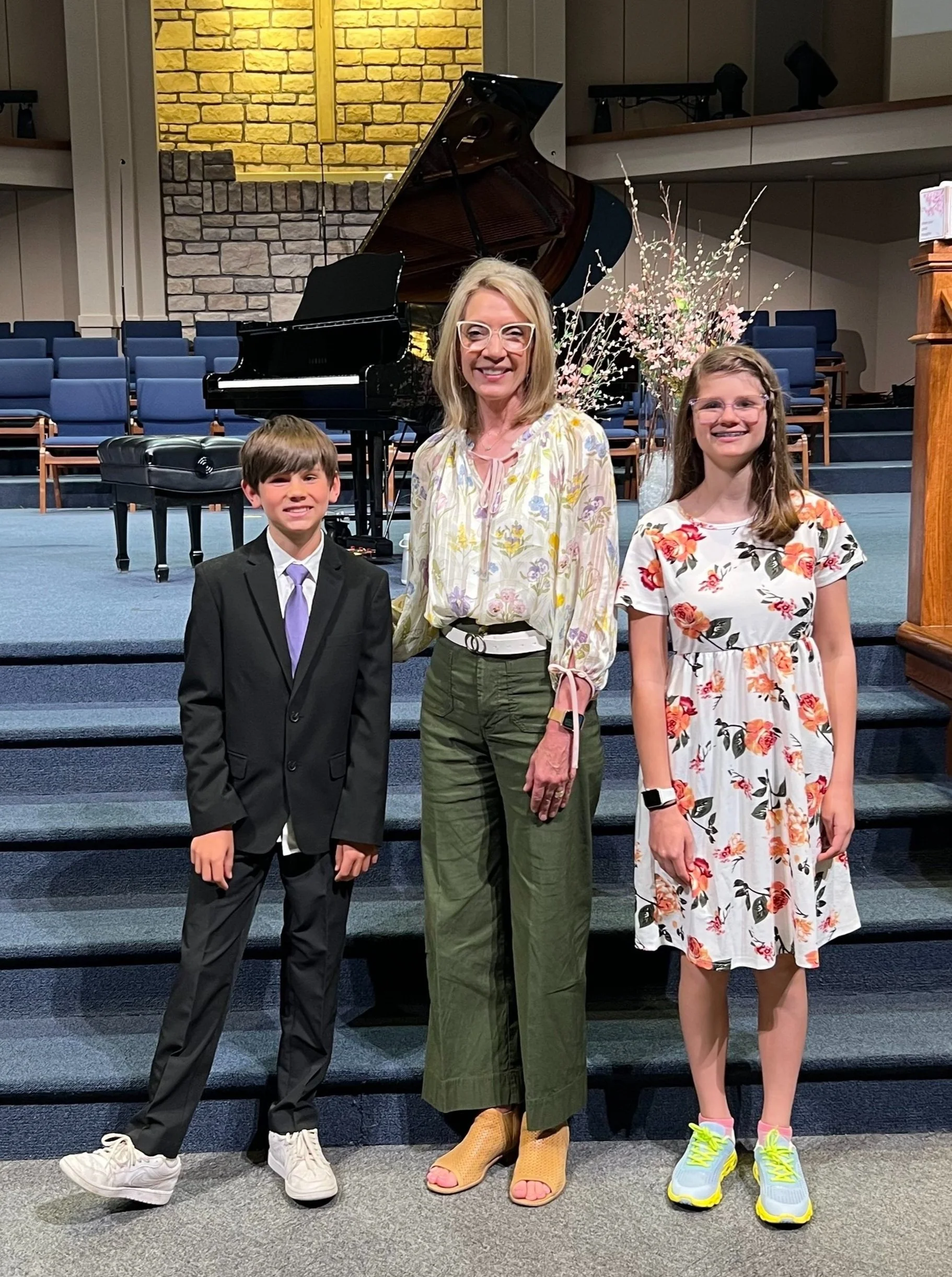 Piano students posing with teacher after recital