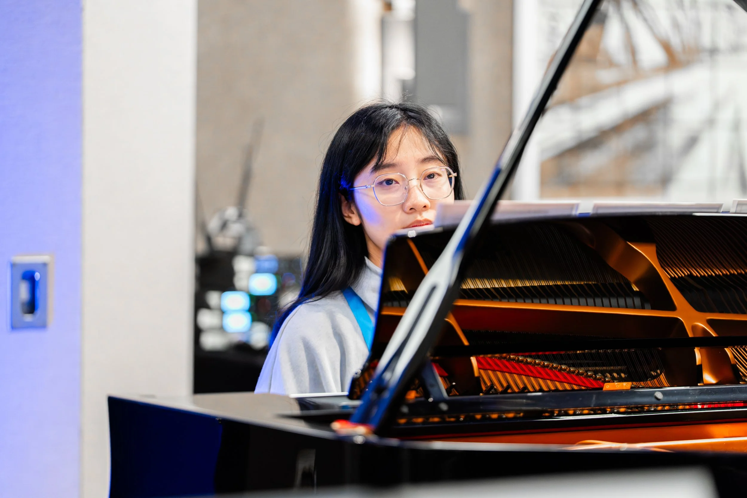 girl with glasses looking at music