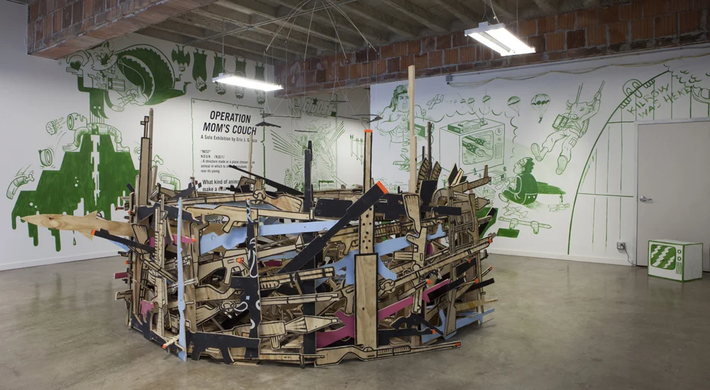 Operation Mom’s Couch Acrylic murals in H20’xW24’xD20’ gallery space, “War Nest”-wooden sculpture H4’x12’Dia, and audio recording by Mike Garcia. Installation at the National Veterans Art Museum, Chicago, IL. 2016 Photos by Juan Giraldo