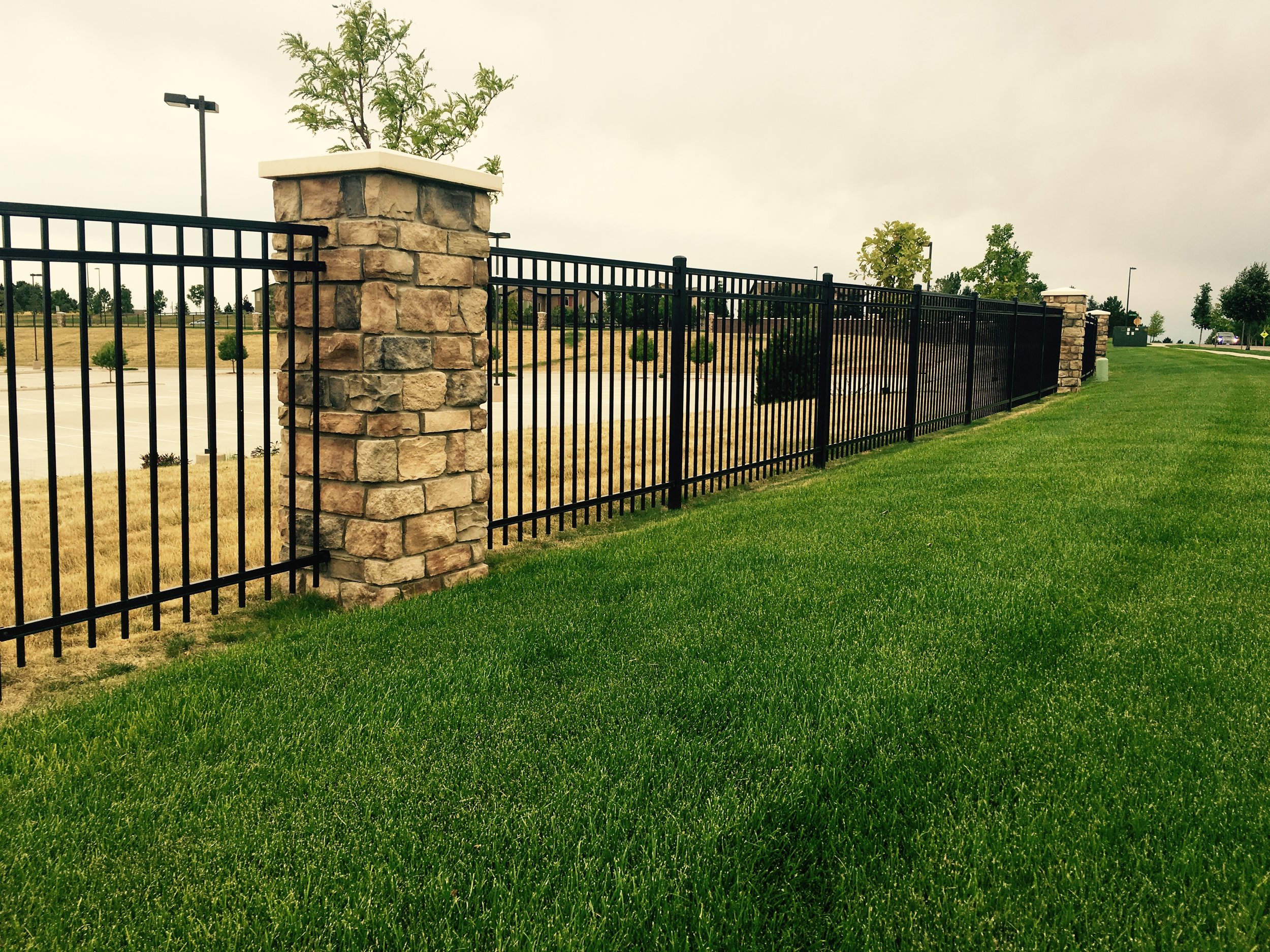 Steel Fencing - 5' Flush Top Picket Bottom - Commercial - Stone Veneer Columns.jpeg