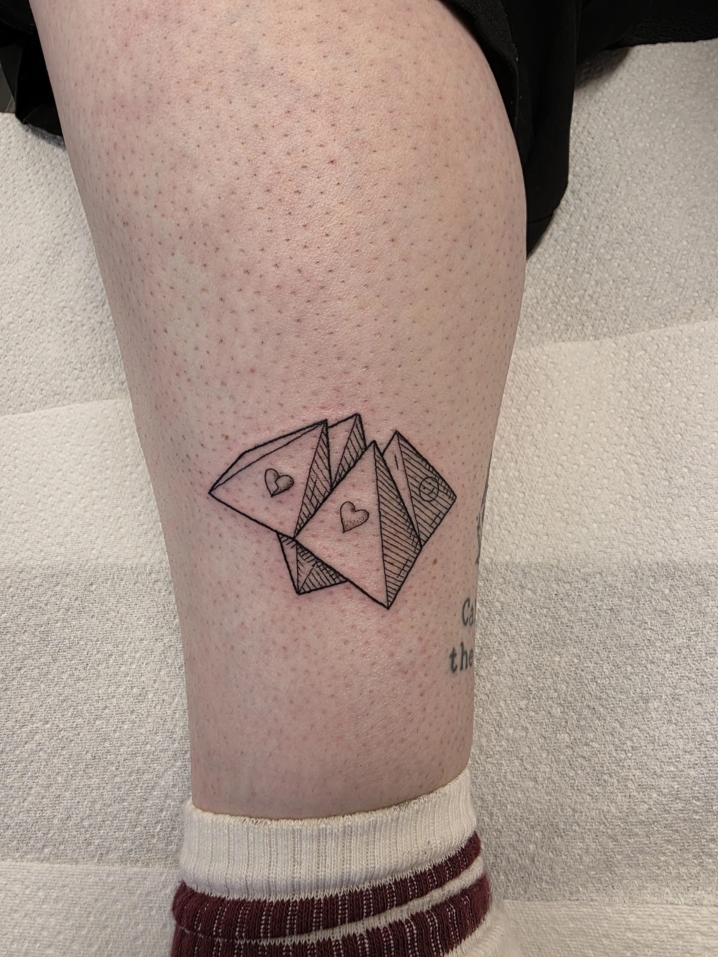 Tatoo of a chatterbox/ fortune teller/ cootie catcher/ chip chop/ comecocos tattoo on the ankle done by Nick Whybrow at The Good Fight tattoo in Camden London