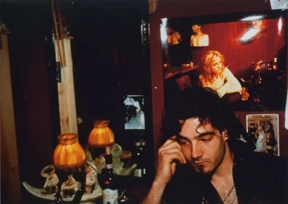 Nan Goldin, Max at Sharon’s apartment under photograph of his mother Cookie, NYC, 1996 (© 2019 Nan Goldin)