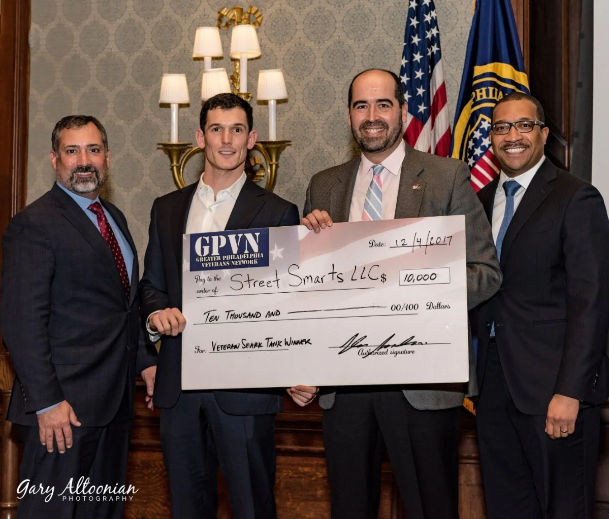 Oliver Noteware accepting award from The Veteran Shark Tank