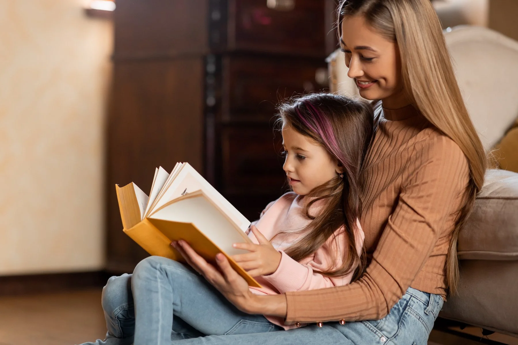 portrait-of-happy-mother-and-daughter-reading-book-2022-12-16-08-16-33-utc.jpg