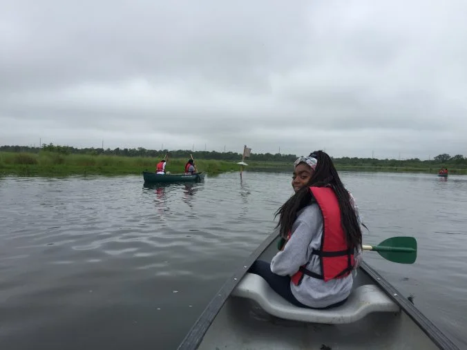 Students explore the wetlands by canoe.