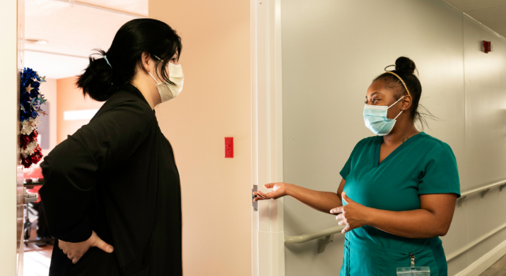 two certified nurse assistants having a conversation