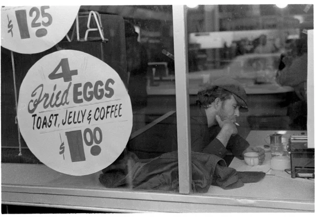 Tom Waits at the Victoria Restaurant , silver gelatin print by Herb Nolan, 1976