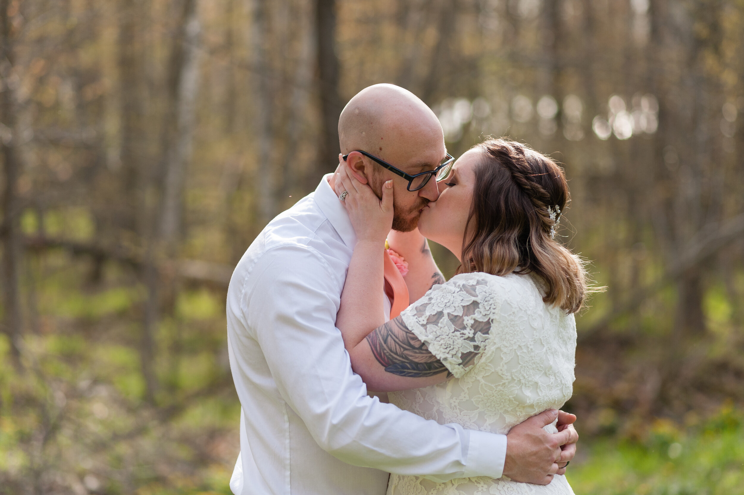 Green Bay backyard woods wedding bride and groom kissing