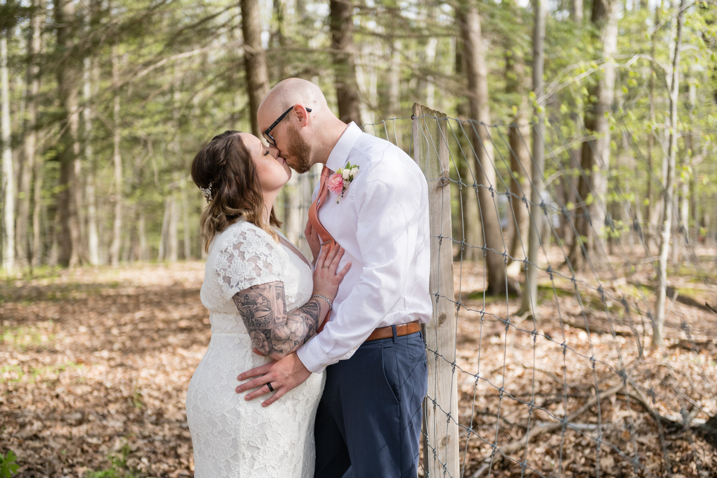 Green Bay wedding in woods bride and groom kissing