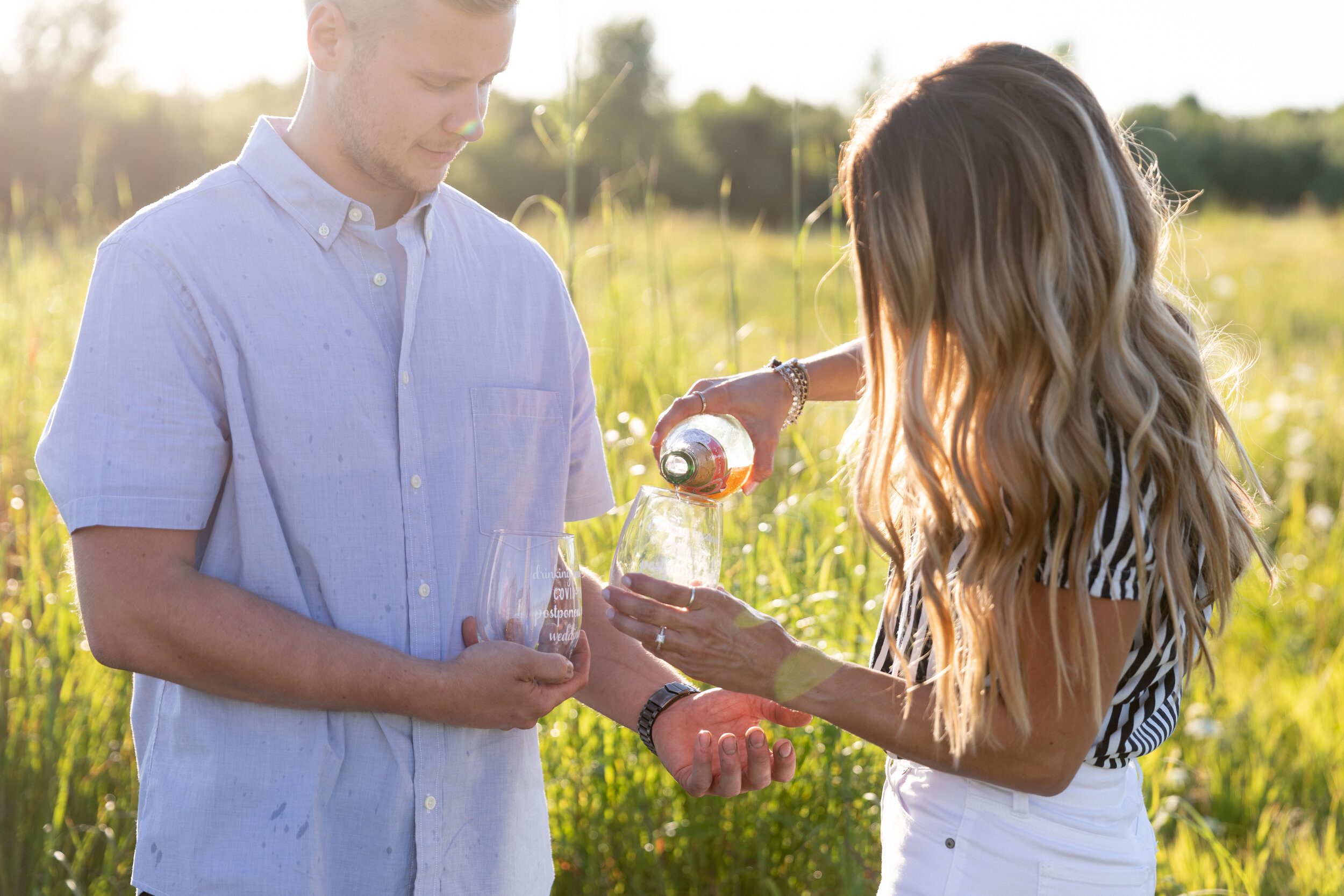 engaged couple pouring wine at Fonferek Glen Green Bay Wisconsin