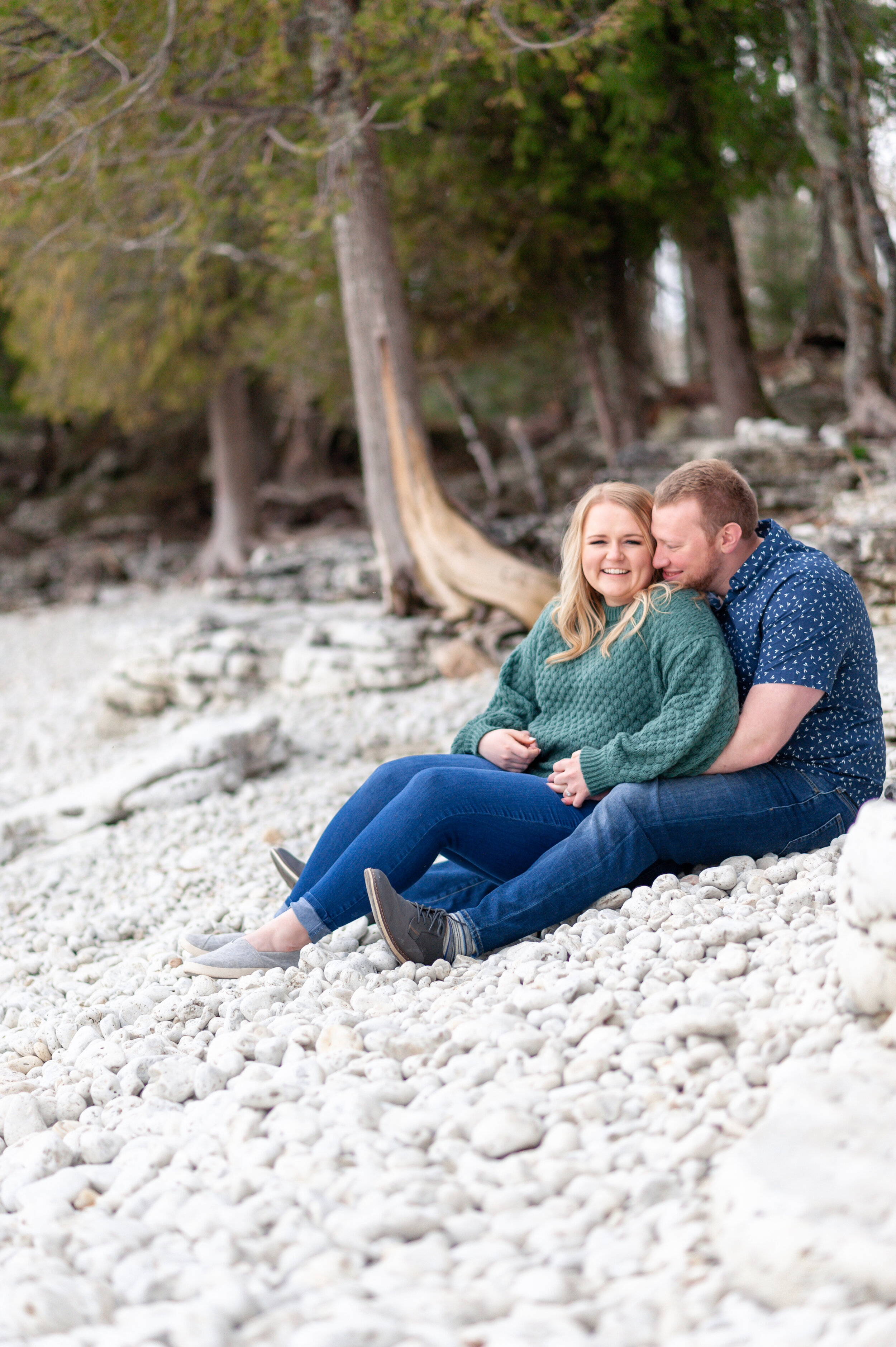 Couple engagement session on woods white pebble beach