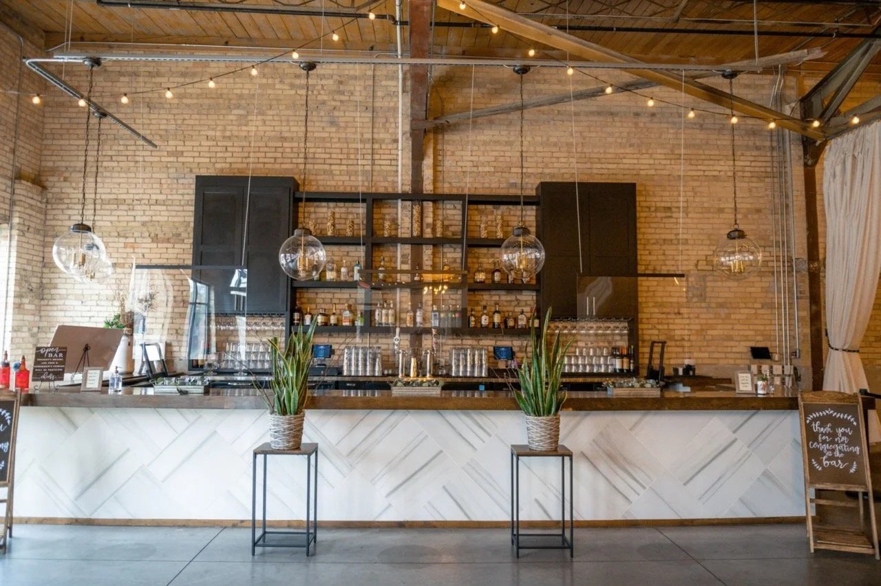 Stunning luxury wedding at Gather on Broadway with industrial chic vibe and string lights and epic bar