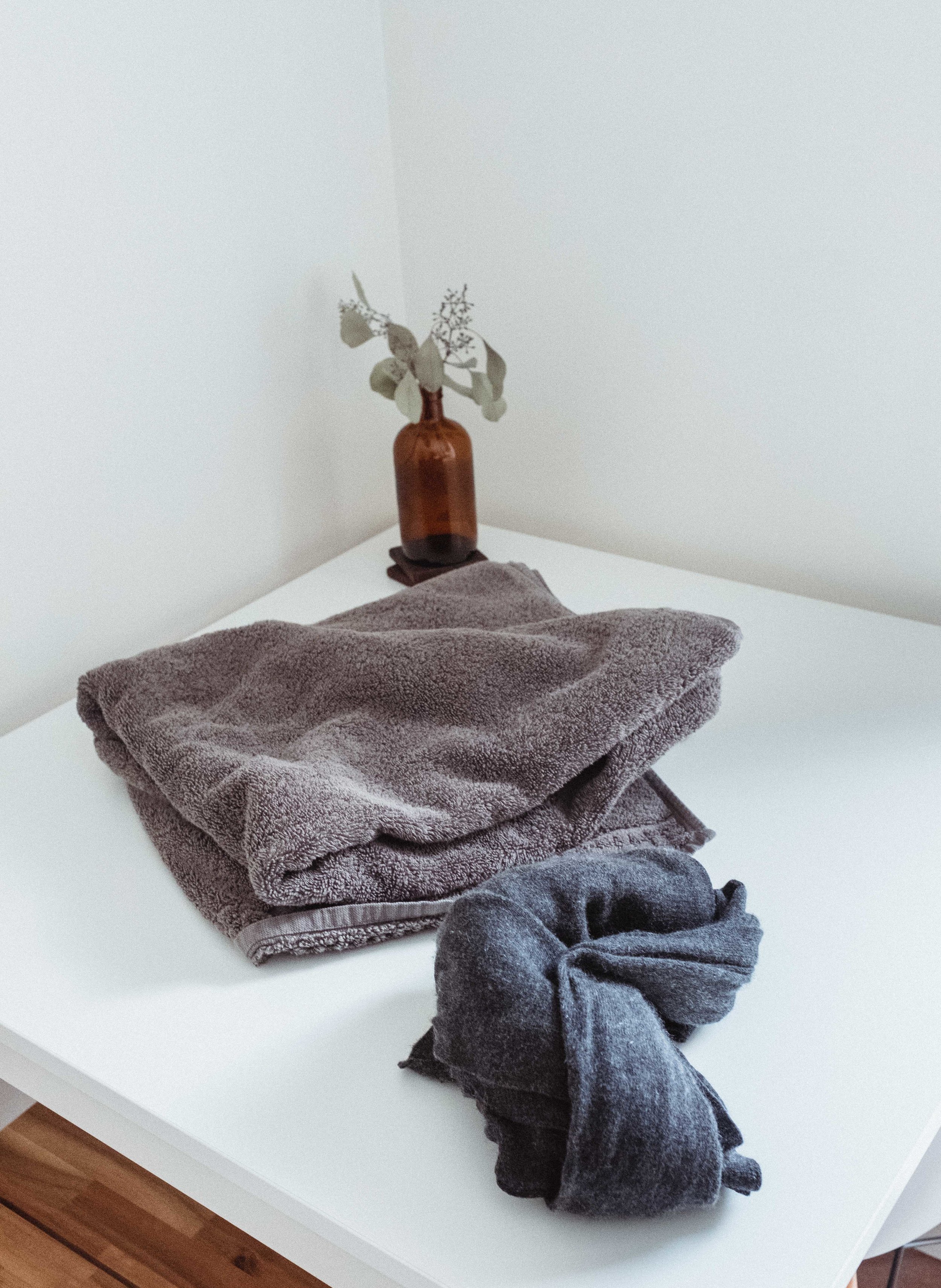 Step 5: next, bring your sweater, along with a towel to a flat surface