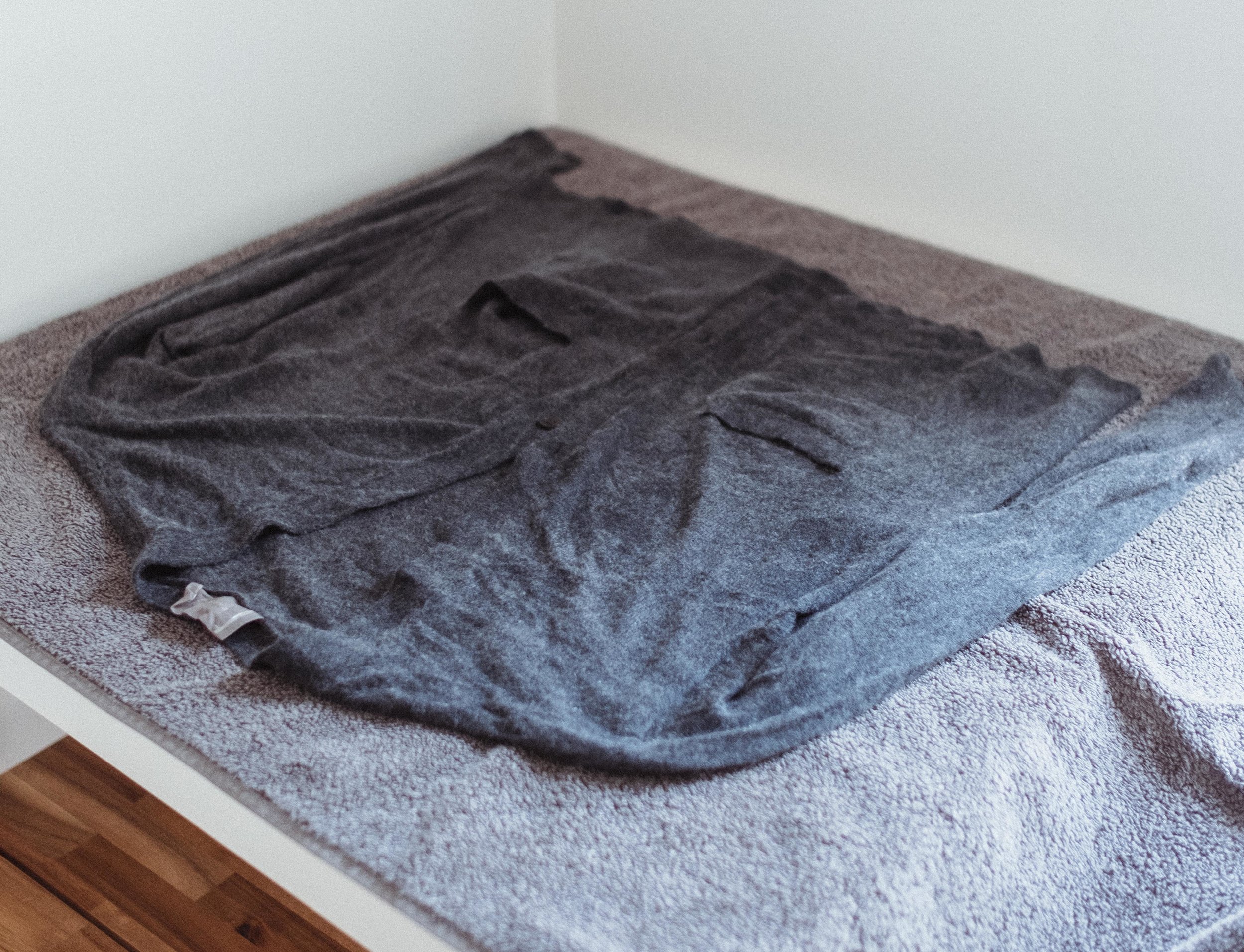 Step 6: reshape the sweater and lay it on a flat surface on top of a towel