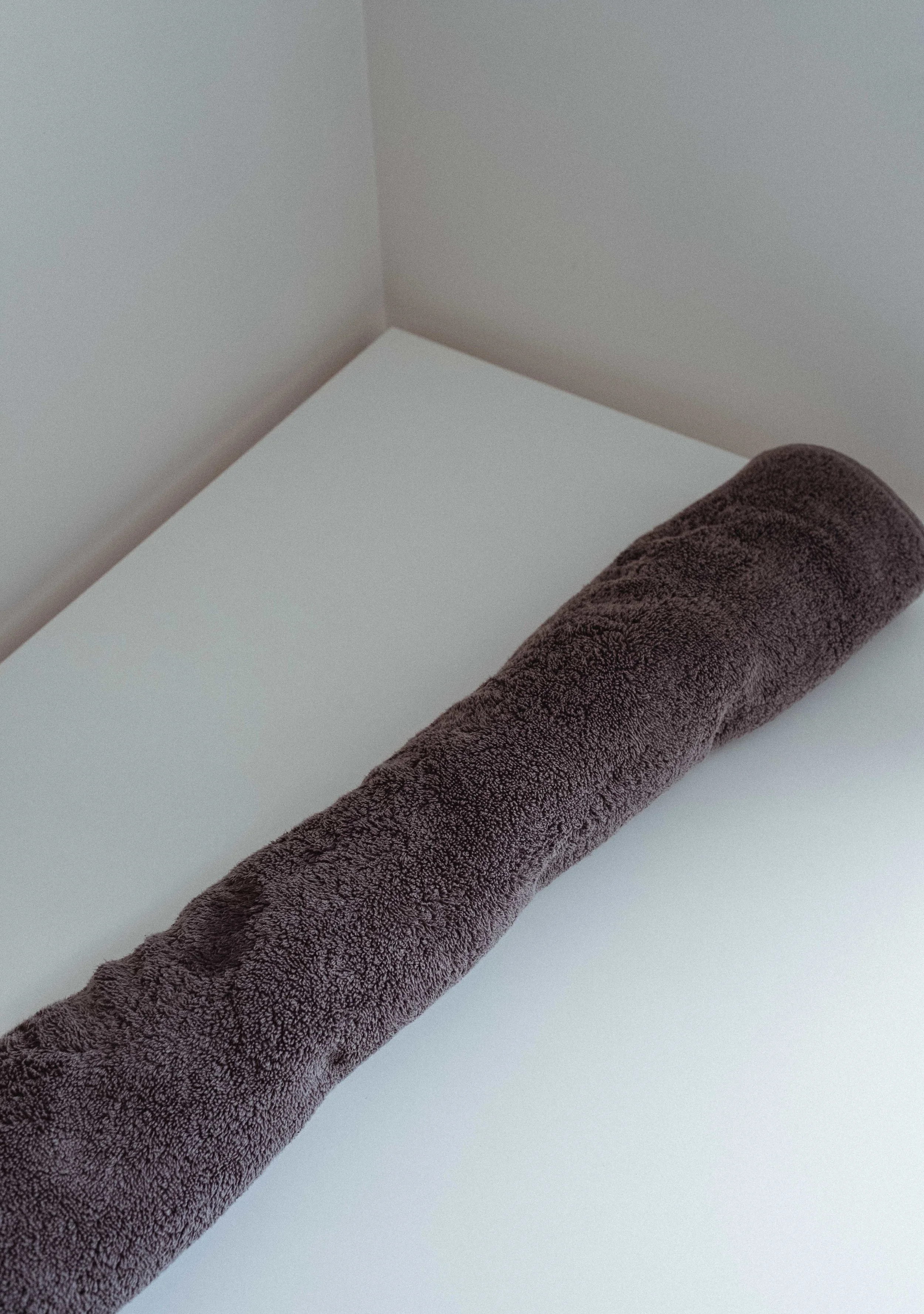 Step 8: once you’ve rolled up your sweater in the towel, push down to squeeze some water out into the towel