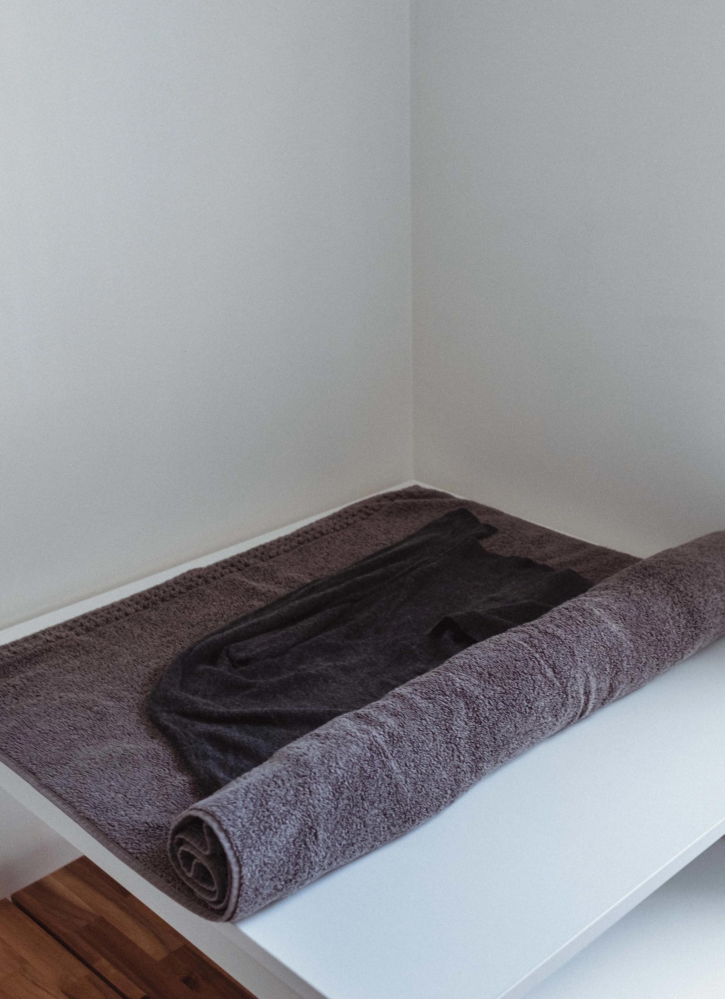 Step 7: begin to roll the sweater up in the towel like a burrito