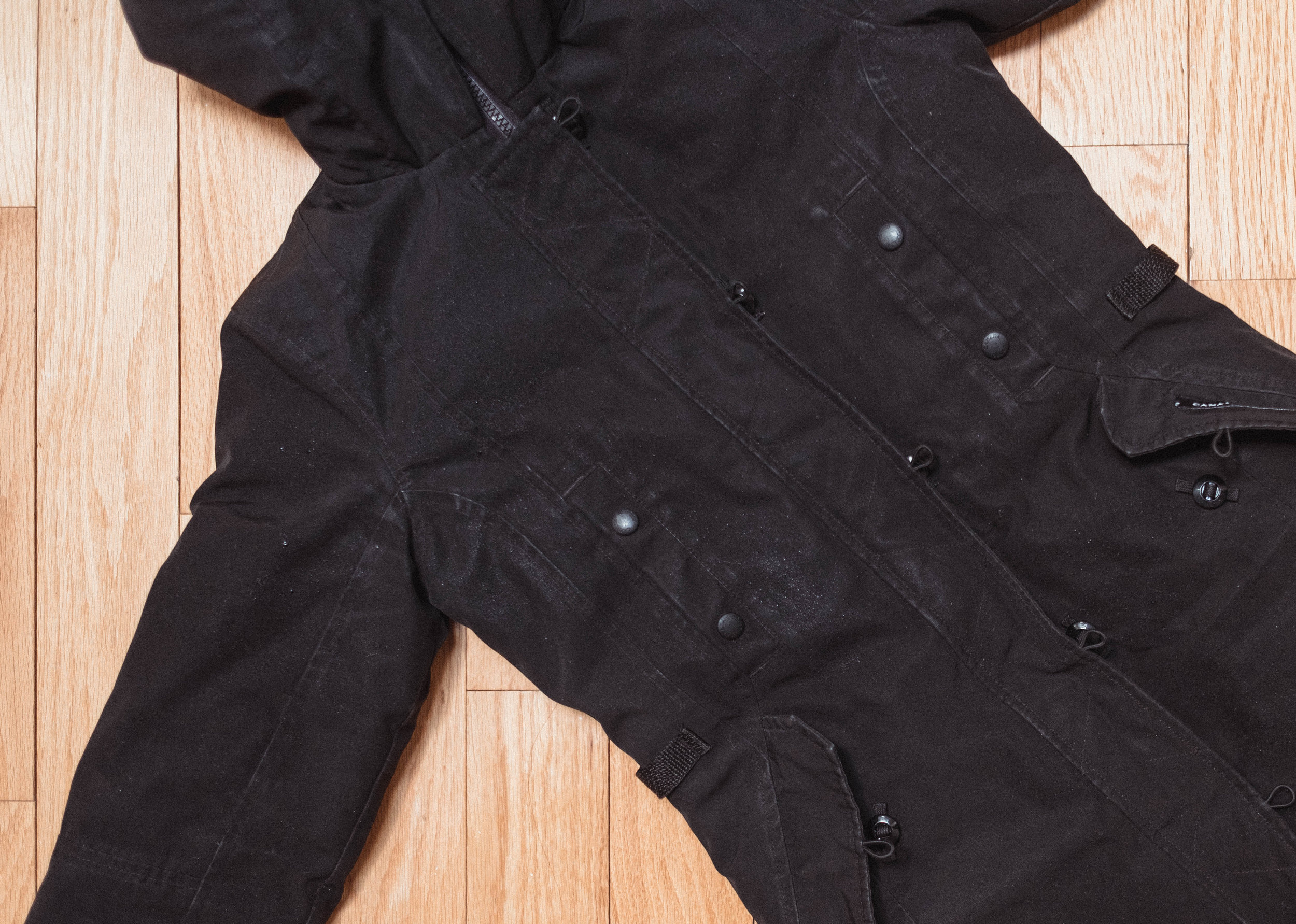 Here I’ve laid out my coat on the floor to do spot cleaning. There is discolouration and some light water stains on the front pockets.