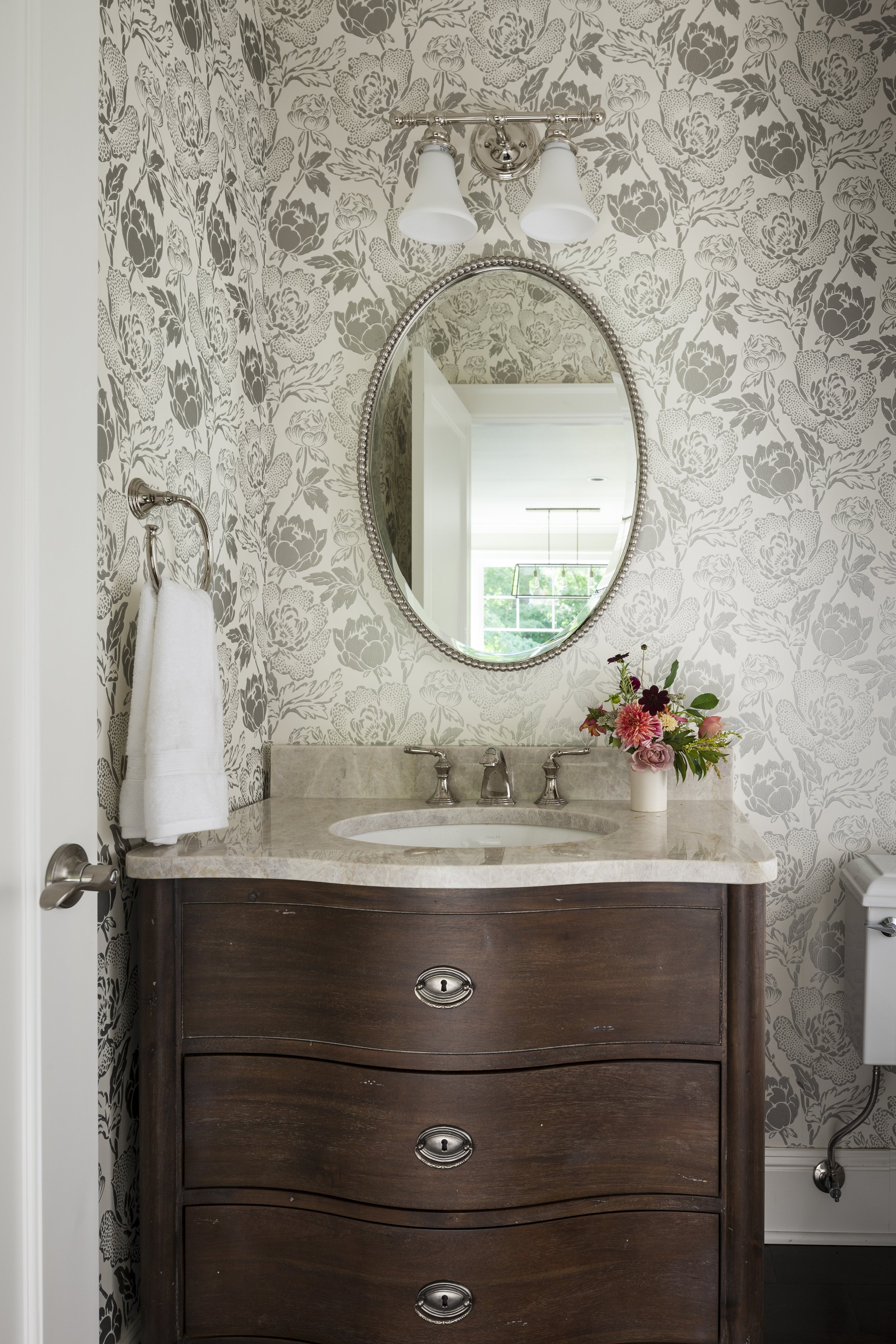 Bellevue craftsman home powder room with floral wallpaper designed by Kimberlee Marie Interiors