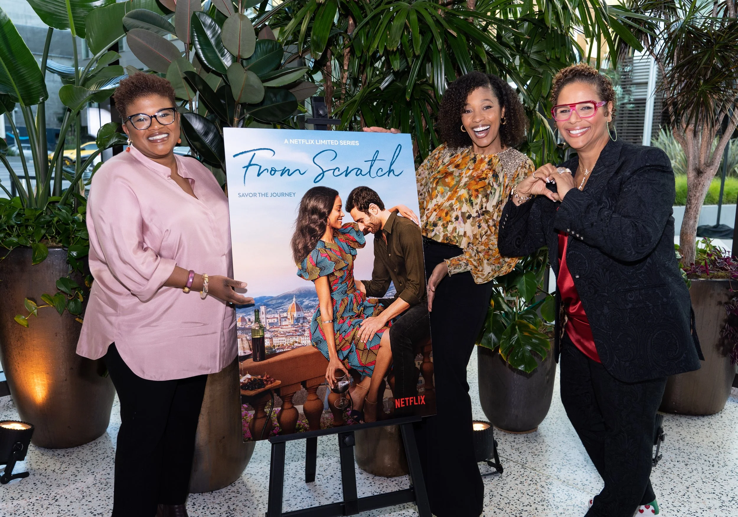 Attica Locke, Tembi Locke, and Yvette Lee Bowser pose with a poster of FROM SCRATCH at WGFestival 2022.