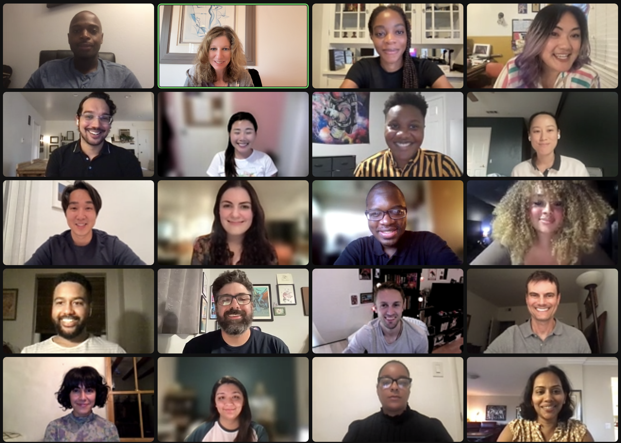 Screenshot of a virtual meeting with 20 diverse people, each in their own home or office, smiling and looking at their cameras.