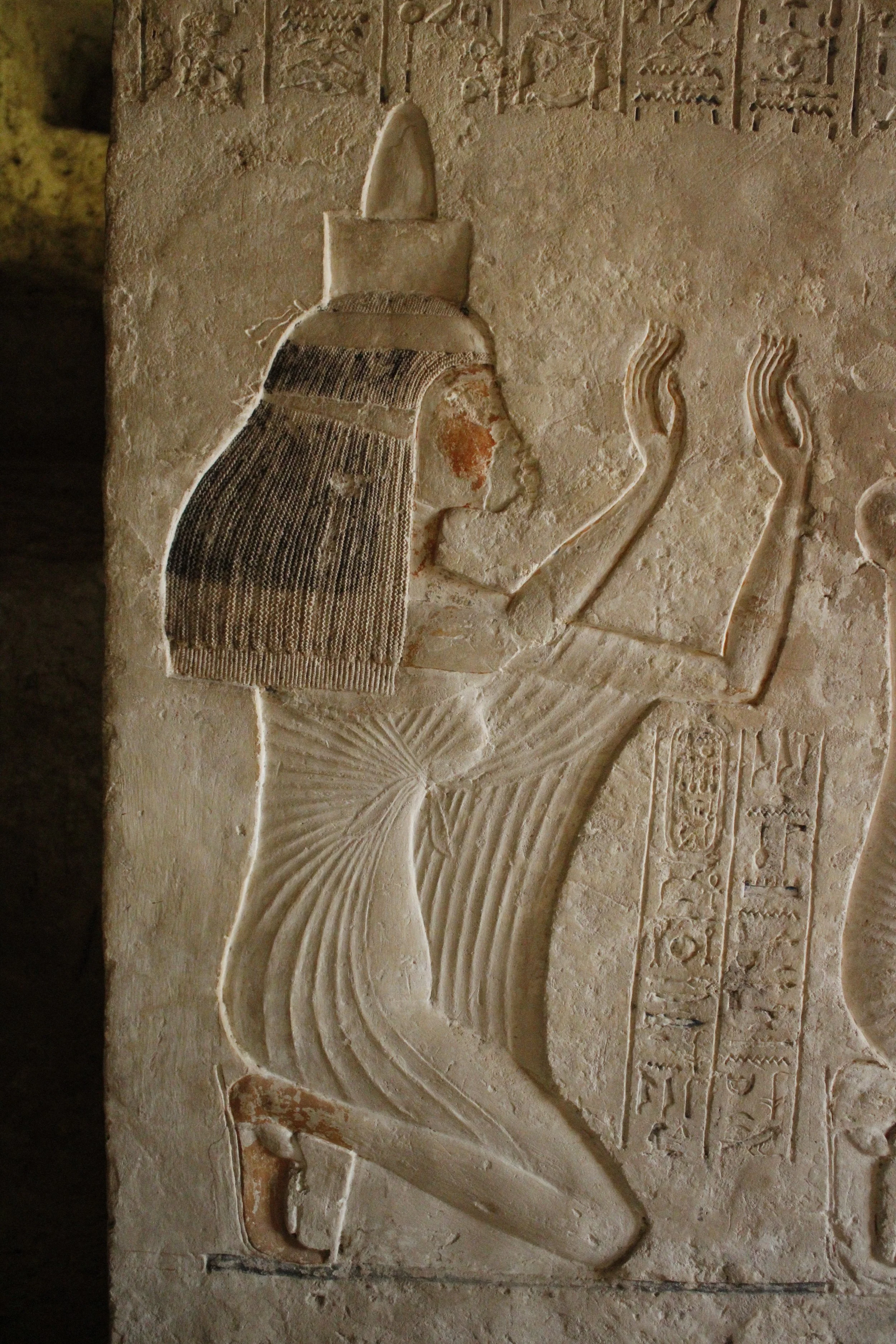 ancient egyptian priestess in prayer. temple wall relief in tell-el amarna, egypt, home of akhenaten
