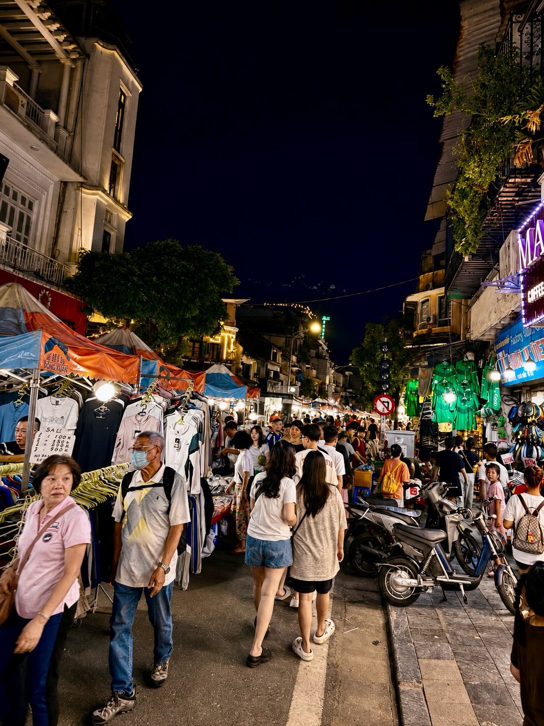 I got scammed by a 7-year-old
In the Old Quarter of Hanoi 
I was smiling 
Clapping
To the people dancing 
Cha cha
Rumba 
Hips swaying and swinging 
Bodies twirling and 
Shoulders shimmying

Fluorescent toys
Whizzed into the blackened canopy above 
A 