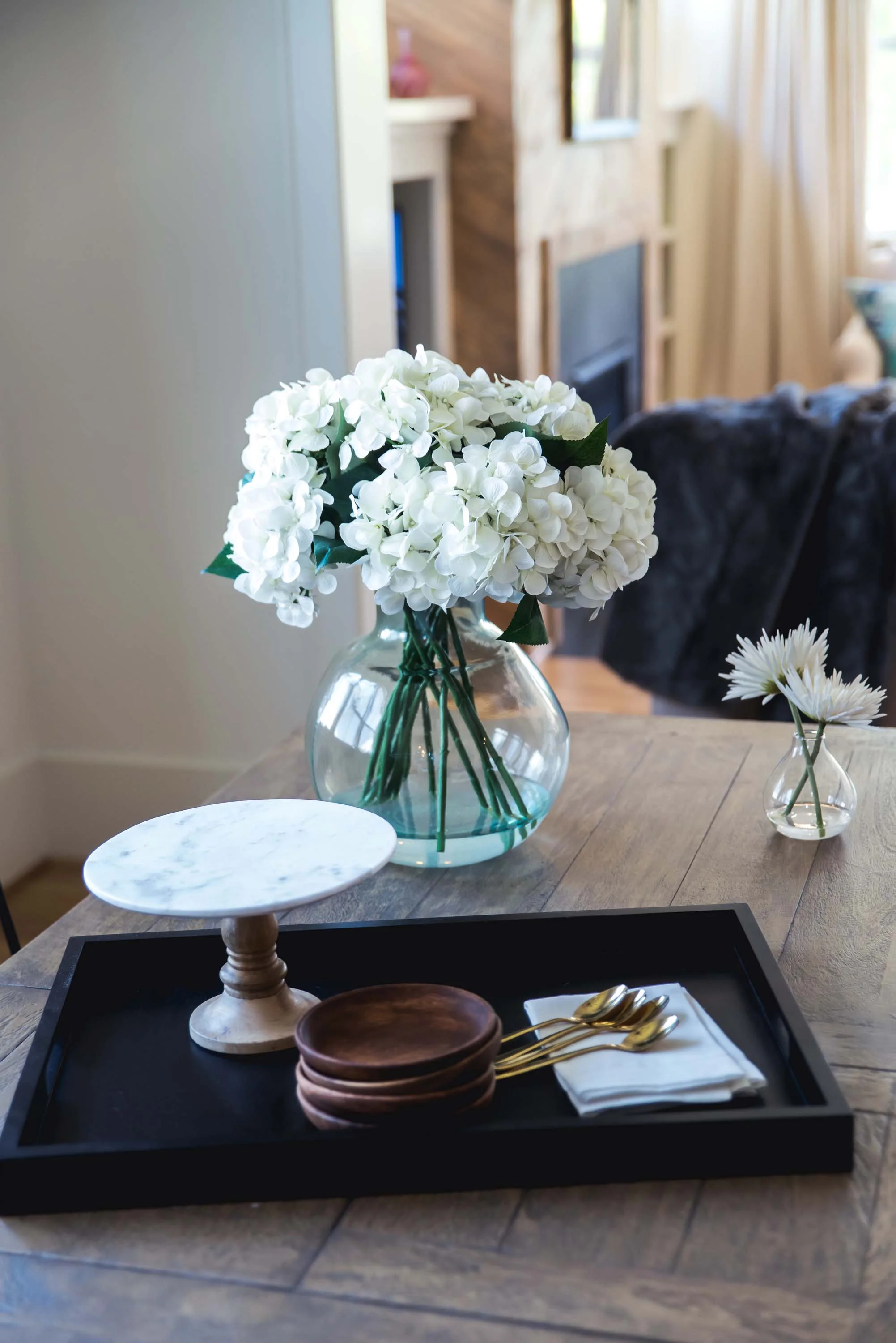 1. Wooden table with wooden serving tray and flower vase