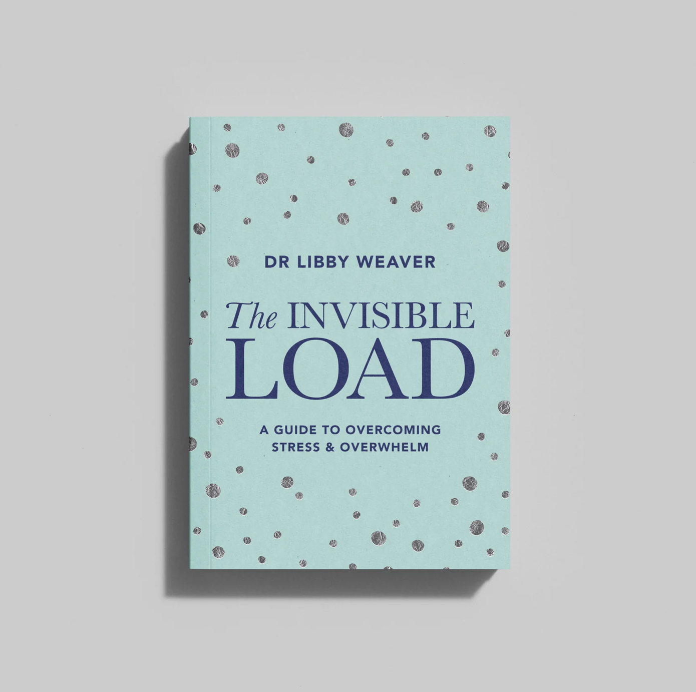 A book titled "The Invisible Load: A Guide to Overcoming Stress & Overwhelm" by Dr. Libby Weaver, with a light blue cover decorated with black and silver dots.