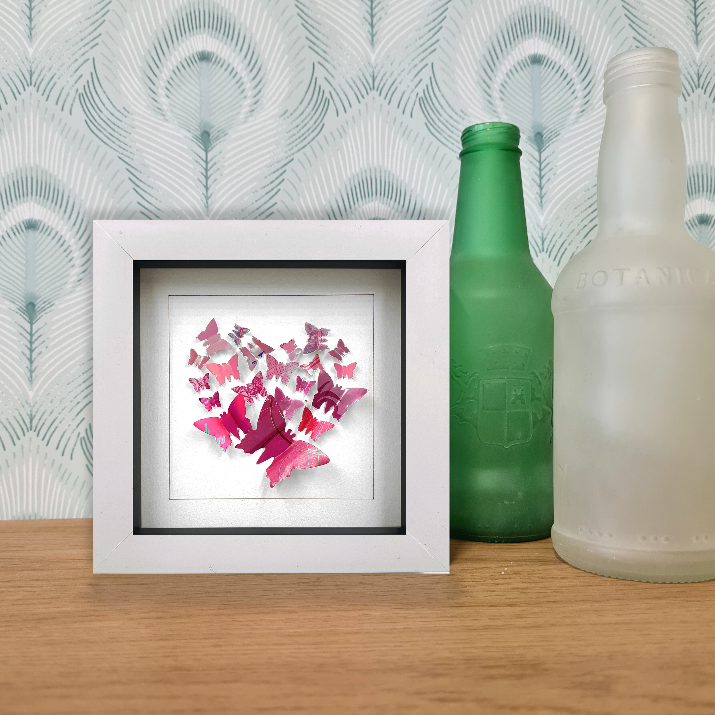 Recycled pink heart butterfly design white frame decoration sitting on desk