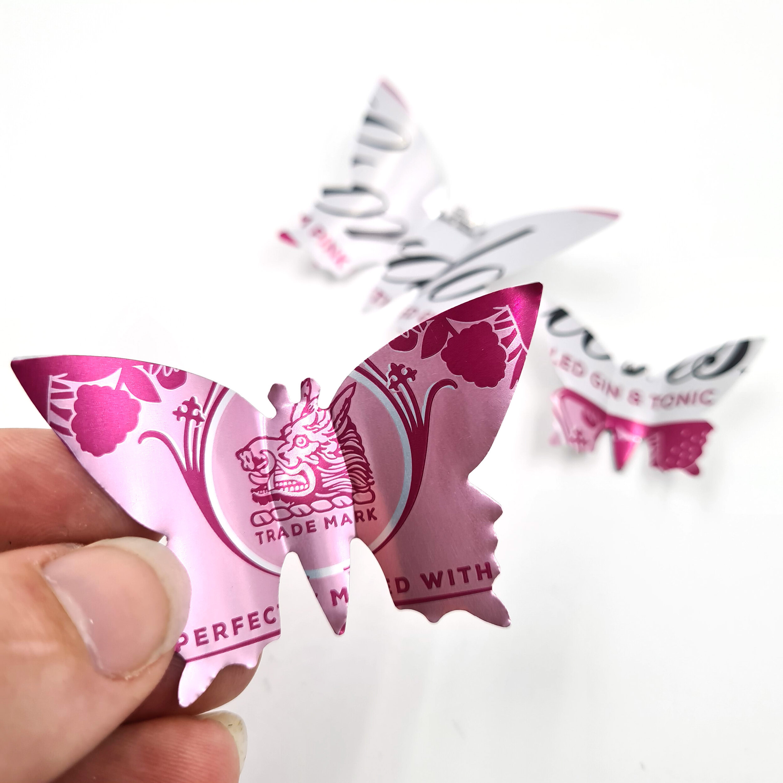 Pink and white sustainable 3D Gin Butterfly Can Magnets holding 